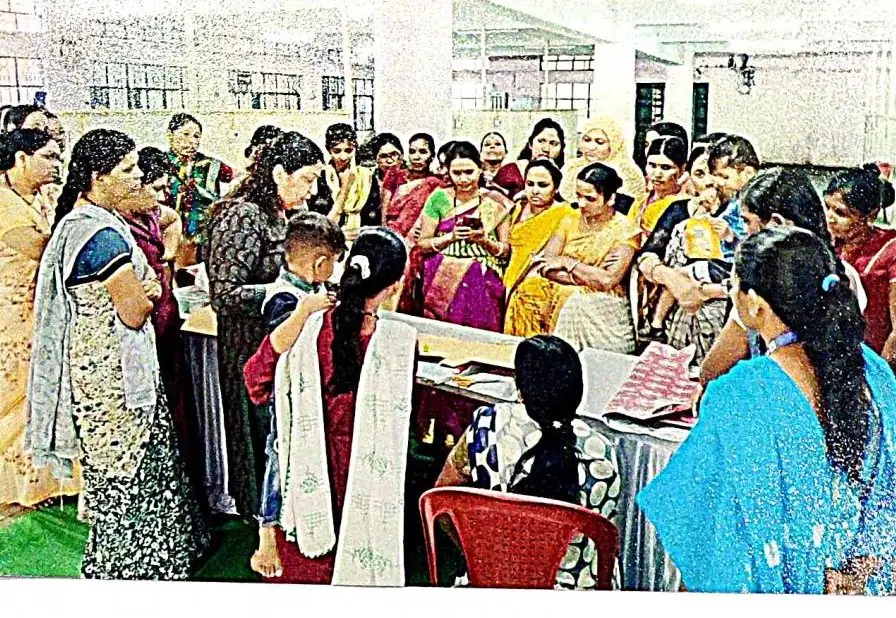Participants gathered around a table of fabric work at the Parbhani bag-making workshop