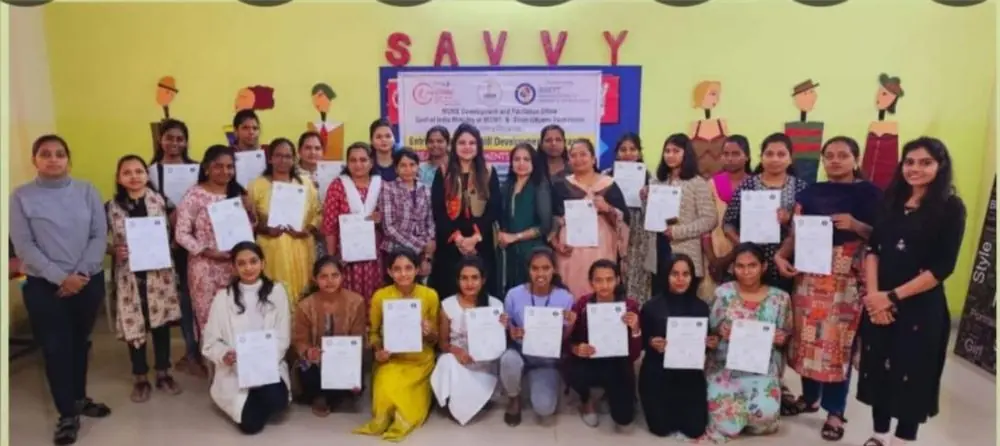 Participants holding certificates after the professional tailoring programme