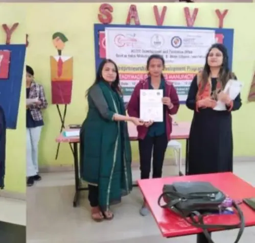 A participant receiving a certificate at the professional tailoring programme